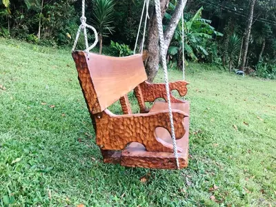 a swing hanging from a tree in a yard at Natural Wonders House in Monteverde Costa Rica