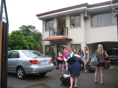 a group of people standing outside of a building at Hotel Santa Maria Inn in Alajuela City