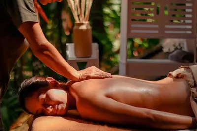 a woman getting a back massage from a therapist at Jardines Secretos in Rivas