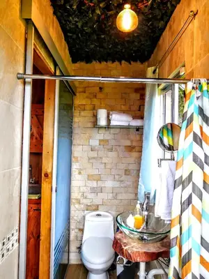 a bathroom with a toilet and a sink at Cabaña Mountain View in Heredia