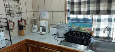 a kitchen with a counter top with a sink and a counter top at Mapi's House in Paquera
