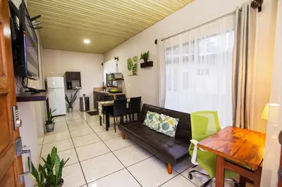 a living room with a couch and a table at Apartamento Lantana ,Monteverde con Aire Acondicionado y Lavanderia in Monteverde Costa Rica