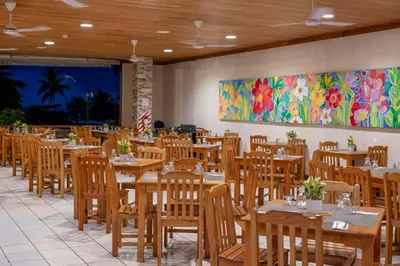 a dining room with wooden tables and chairs at Best Western Jaco Beach All Inclusive Resort in Jacó