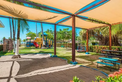 a playground with a picnic table and a bench at Best Western Jaco Beach All Inclusive Resort in Jacó