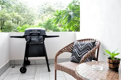 a grill on a stand next to a table at Pazifico Villas in Playa Avellana