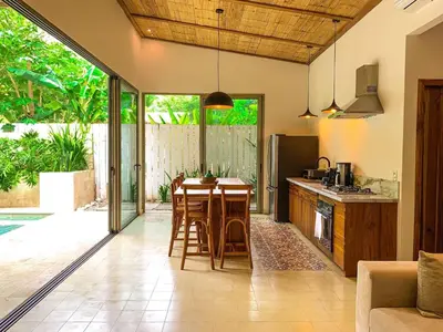 a kitchen with a table and chairs in a room at Casa Keshet in Santa Teresa Beach