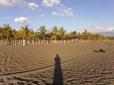a shadow of a person standing on a beach at 12B Jaco Sol Quadplex in Jacó