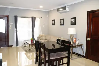 a living room with a table and a couch at 12B Jaco Sol Quadplex in Jacó