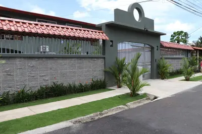 a house with a gate on the side of it at 12B Jaco Sol Quadplex in Jacó