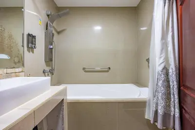a bathroom with a white tub and a sink at Jaco Sol Quadplex 11A in Jacó