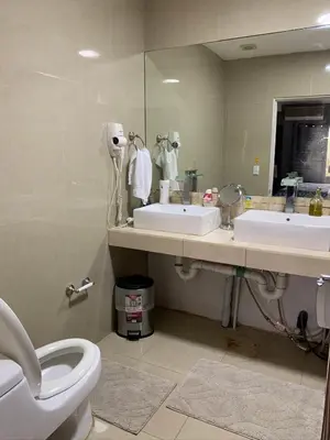 a bathroom with two sinks and a toilet and a mirror at Jaco Sol Quadplex 11A in Jacó