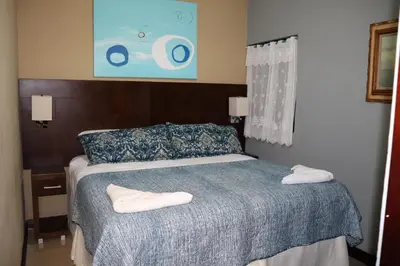 a bedroom with a bed with two towels on it at 11B Jaco Sol Quadplex in Jacó