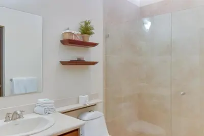 a bathroom with a shower and a toilet and a sink at The Cove at Playa Ocotal, units 5,6,7 and 8 in Coco