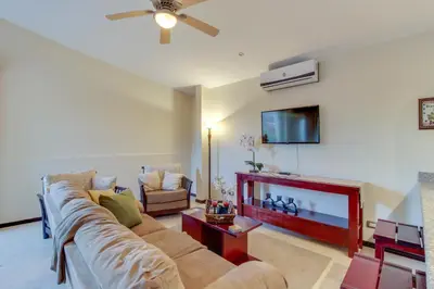 a living room with a couch and a tv at The Cove at Playa Ocotal, units 5,6,7 and 8 in Coco