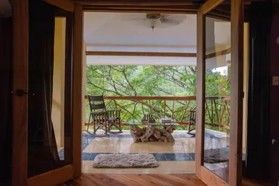 a glass door leading to a patio with a table at Casa Monos Locos - Portasol Vacation Rentals in Portalón