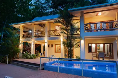 a house with a swimming pool in front of it at Casa Monos Locos - Portasol Vacation Rentals in Portalón