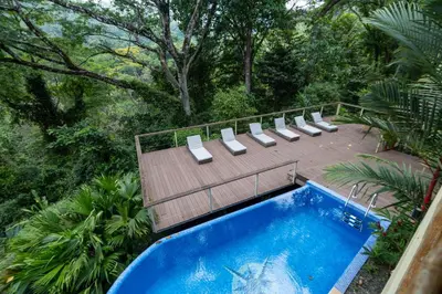 an overhead view of a pool with chairs and a deck at Casa Monos Locos - Portasol Vacation Rentals in Portalón