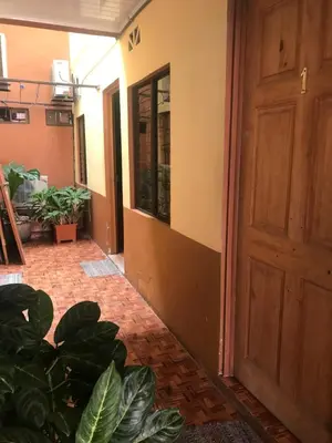 an empty room with a door and some plants at Cabinas Yolymar in Puntarenas