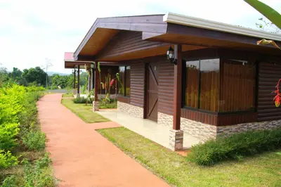 a small house with a walkway in front of it at Cabañas Sueños del Arenal in Fortuna