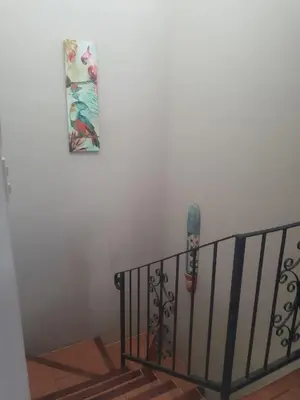 a picture hanging on a wall next to a staircase at Casa Sueno Colibri in Tamarindo