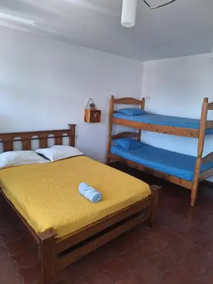 a bedroom with two bunk beds and a yellow mattress at Hotel Cortez Azul in Alajuela City