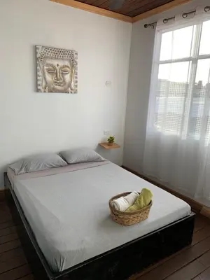 a bedroom with a bed with a basket on it at Hotel Cortez Azul in Alajuela City