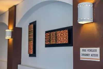a sign on a wall with some pictures on it at ALAJUELA CITY Hotel & Guest House in Alajuela City