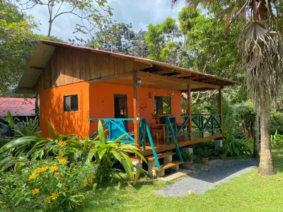 a small house with a porch and a deck at Casa Colores in Montezuma