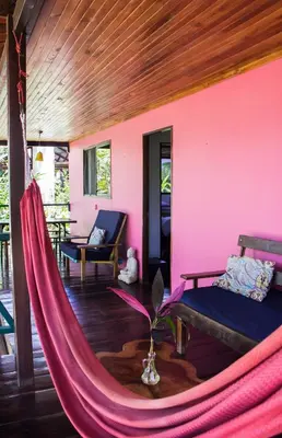 a room with a hammock in a house at Casa Colores in Montezuma