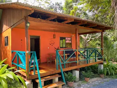 a small house with an orange and blue porch at Casa Colores in Montezuma