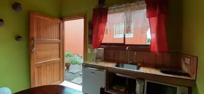 a small kitchen with a sink and a window at Alojamientos Norte y Sur in Monteverde Costa Rica