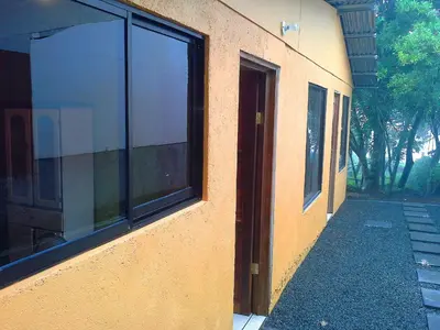 a building with large windows on the side of it at Alojamientos Norte y Sur in Monteverde Costa Rica