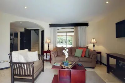 a living room with a couch and a table at The Cove 3/4 in Coco