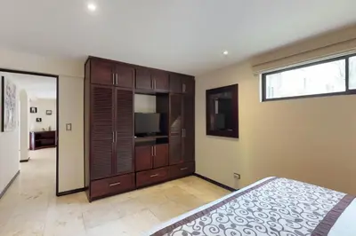 a bedroom with a bed and a television in it at The Cove 3/4 in Coco