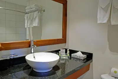 a bathroom with a white sink and a mirror at Country Inn & Suites by Radisson, San Jose Aeropuerto, Costa Rica in San José
