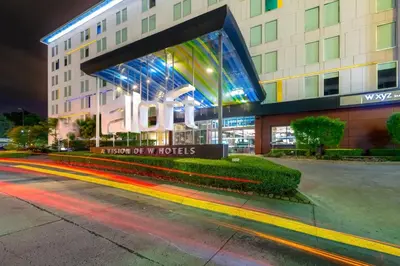 a building with a sign in front of it at Aloft San Jose Hotel, Costa Rica in San José