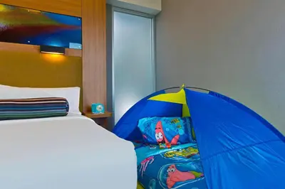 a bedroom with a blue tent next to a bed at Aloft San Jose Hotel, Costa Rica in San José