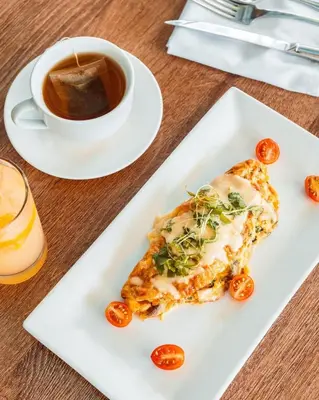 a plate with a slice of pizza and a cup of coffee at Aloft San Jose Hotel, Costa Rica in San José