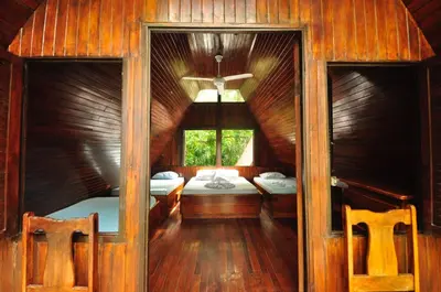 a bedroom with two beds and a window at Howler Monkey Hotel in Montezuma