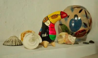 a figurine sitting on a shelf with other items at Howler Monkey Hotel in Montezuma