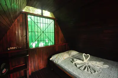a small room with a bed and a window at Howler Monkey Hotel in Montezuma