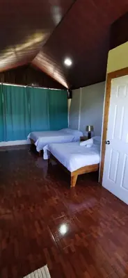 a bedroom with two beds and a door at Mora's Place B&B in Monteverde Costa Rica