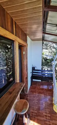 a room with a bench and a table and a window at Mora's Place B&B in Monteverde Costa Rica