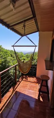 a hammock on a balcony with a view at Mora's Place B&B in Monteverde Costa Rica