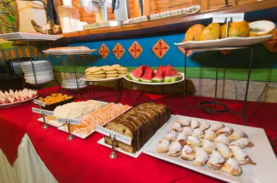 a table topped with different types of bread and other foods at Adventure Inn in San José