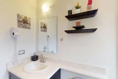 a bathroom with a sink and a mirror at The Cove 9/10 in Ocotal
