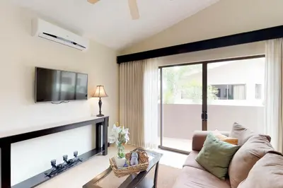 a living room with a couch and a tv at The Cove 9/10 in Ocotal