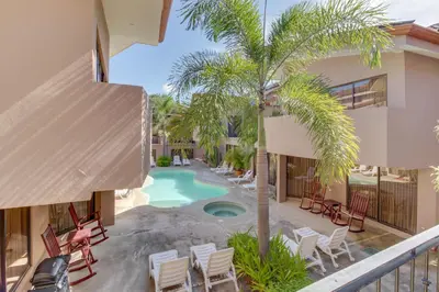 an aerial view of a resort with a pool and palm trees at The Cove 9/10 in Ocotal