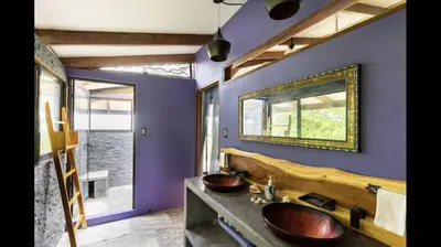 a bathroom with a wooden sink and a mirror at Private Home in Montezuma with Ocean View in Montezuma