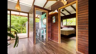 a room with a bedroom and a bed and windows at Private Home in Montezuma with Ocean View in Montezuma